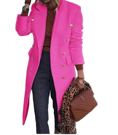 Person wearing a bright pink coat with gold buttons, standing outdoors.
