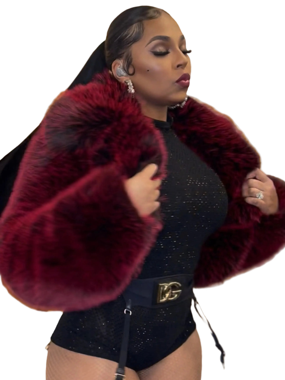 Person wearing a dark outfit with a red fur stole against a blurred background