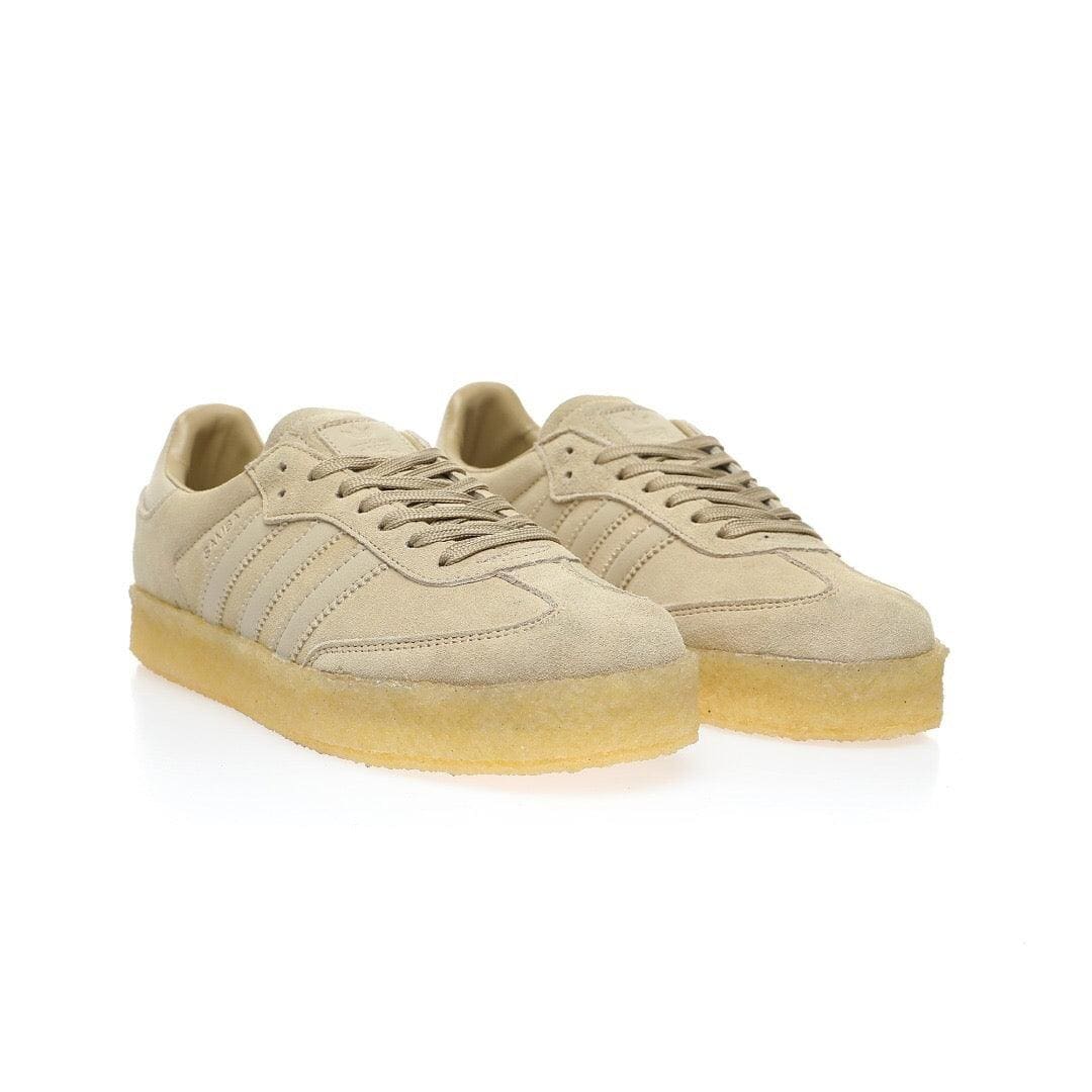 Pair of beige sneakers with a white background