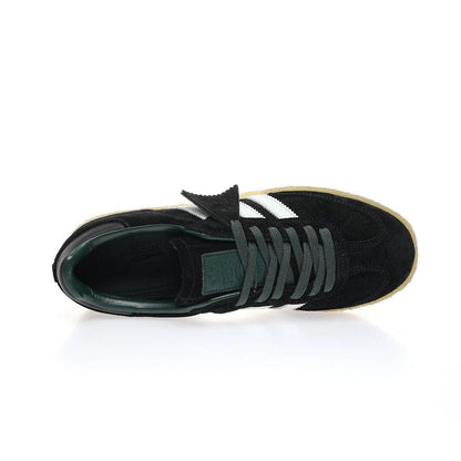 Black sneaker with white stripes on a white background