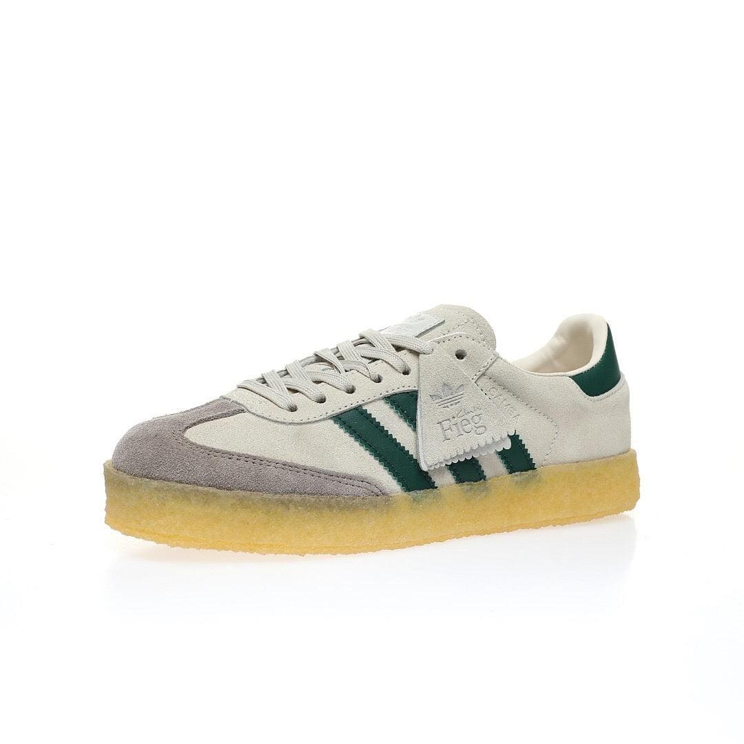 An Adidas Samba sneaker featuring a light beige suede and grey mesh upper, dark green three-stripes and heel tab, and a translucent yellow gum sole, shown against a plain white background.