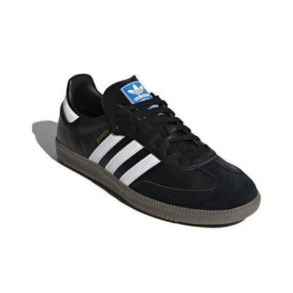 Black Adidas sneaker with white stripes on a white background