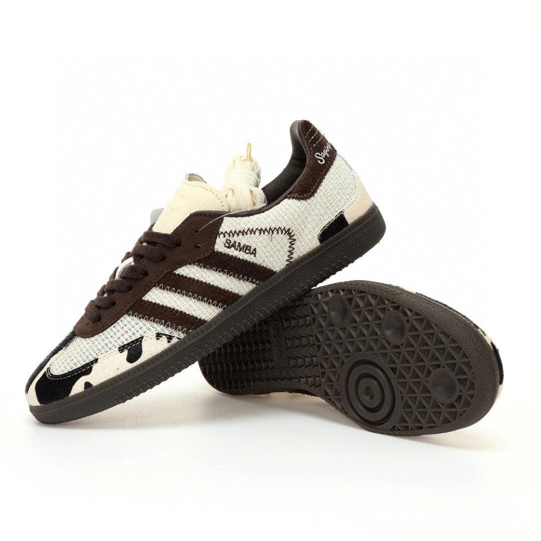Pair of Adidas sneakers with a white and brown design on a white background