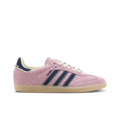 Pink sneaker with navy stripes and white laces on a white background