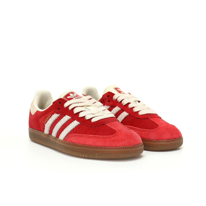 Red sneakers with white soles and brown soles on a white background