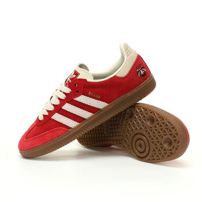 Red sneakers with white stripes on a white background