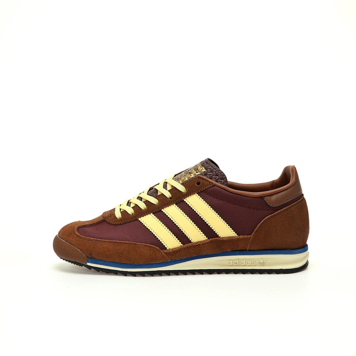 Brown and beige sneaker with Adidas stripes on a white background