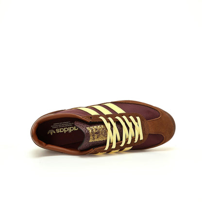 Brown and yellow Adidas sneaker on a white background