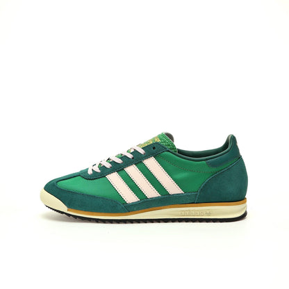 Green Adidas sneaker with white stripes on a white background
