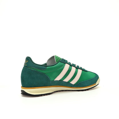Green Adidas sneaker with white stripes on a white background