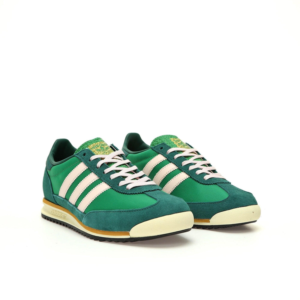 Green sneakers with white stripes on a white background