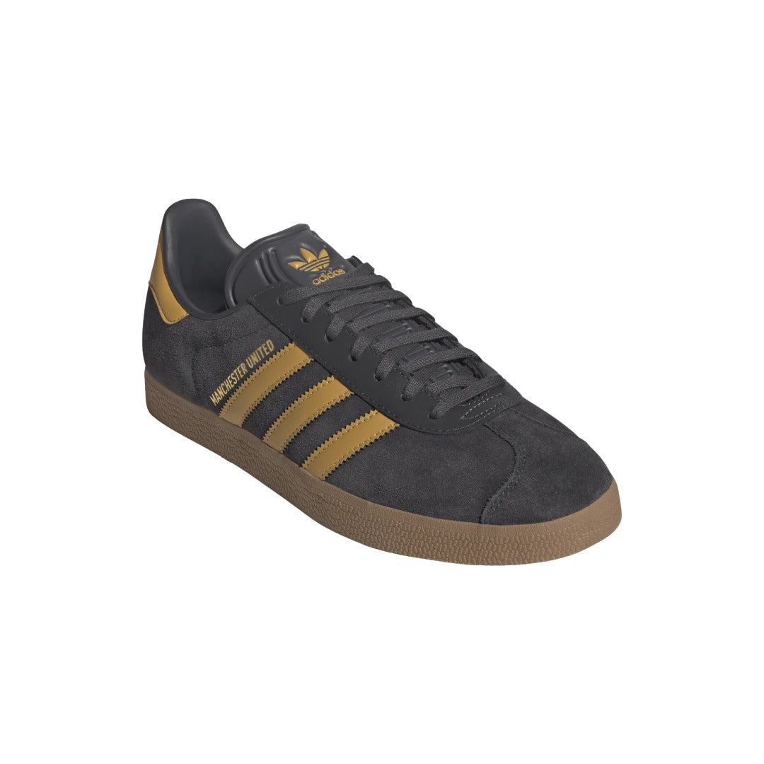 Dark gray Adidas sneaker with gold stripes on a white background