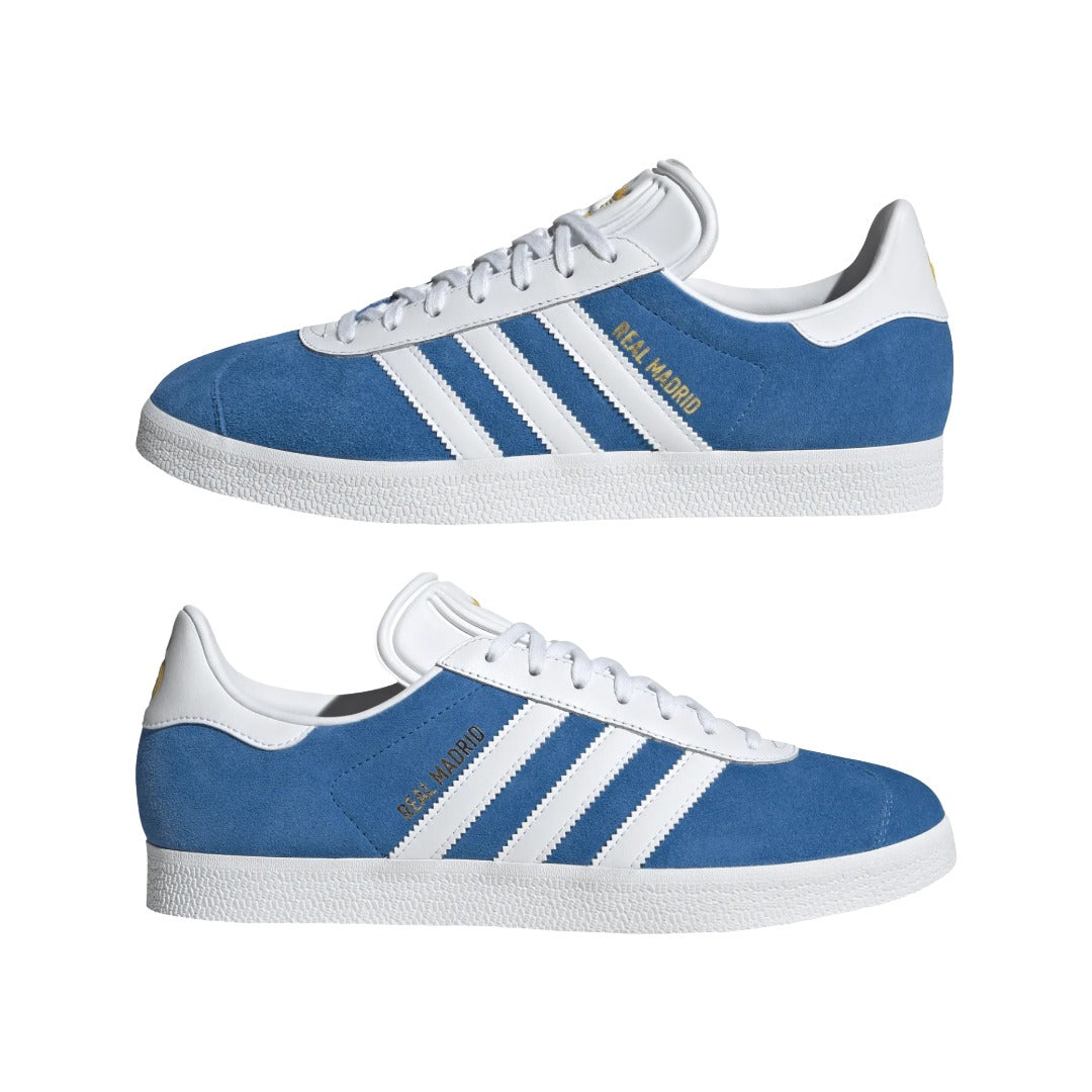 Blue and white Adidas sneakers with three stripes on a white background