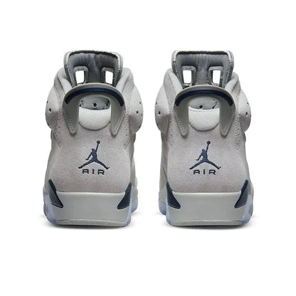 Pair of gray sneakers with a logo on a white background