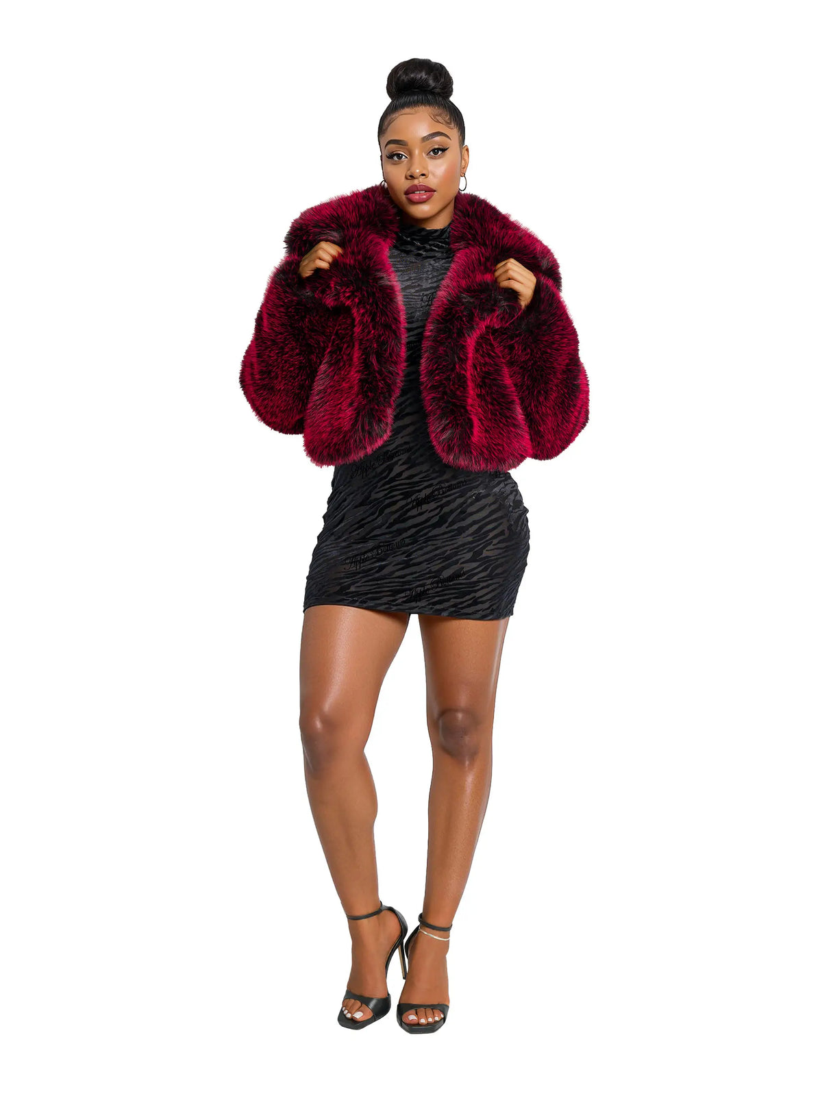 Woman wearing a red fur coat and black dress on a white background
