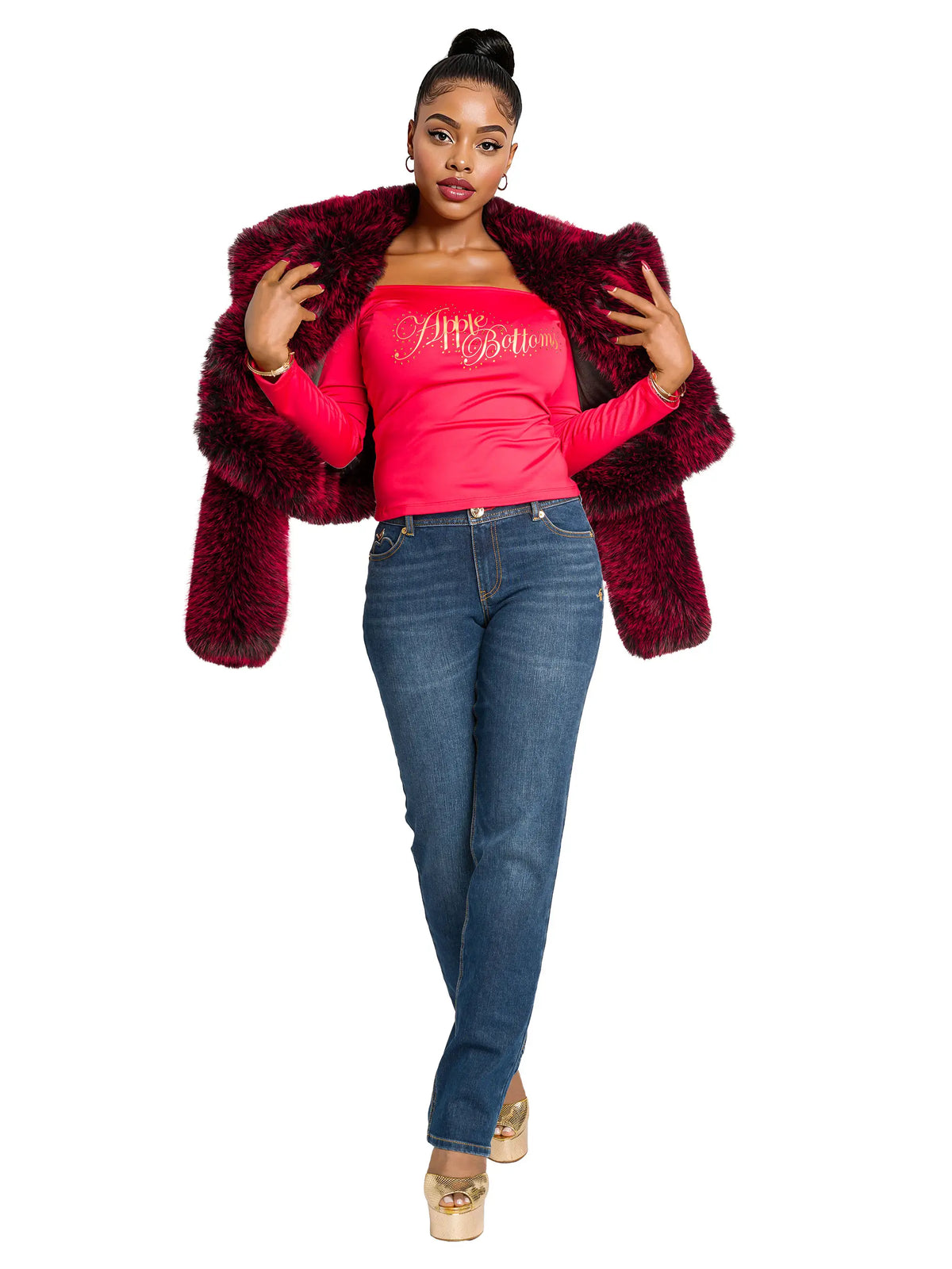 Woman wearing a red fur coat, pink top, and blue jeans on a white background