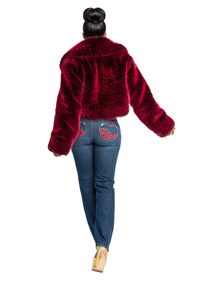 Person wearing a red fluffy jacket and blue jeans on a white background