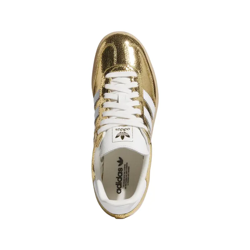 Gold and white Adidas sneaker on a white background