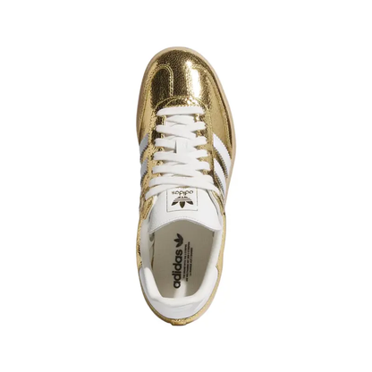 Gold and white Adidas sneaker on a white background