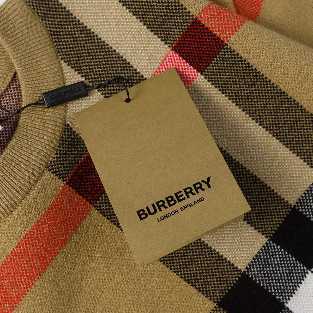 Burberry tag on a checkered fabric background