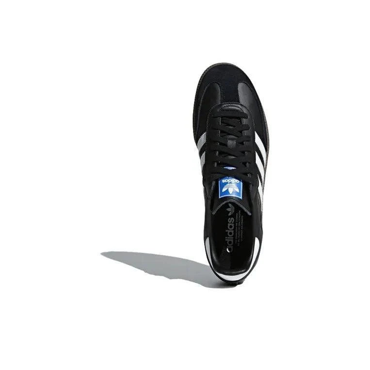 Black Adidas sneaker with white stripes on a white background