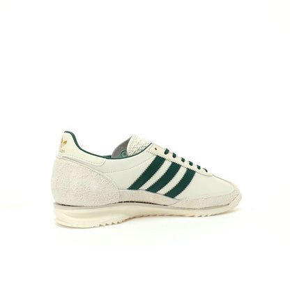White sneaker with green stripes on a white background