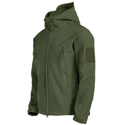 An olive green hooded tactical jacket with multiple zippered pockets and a hook-and-loop patch panel on the upper sleeve, shown against a plain white background.
