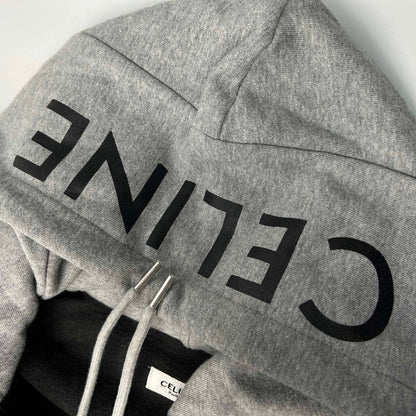 Gray hoodie with 'CELINE' branding on a light gray background