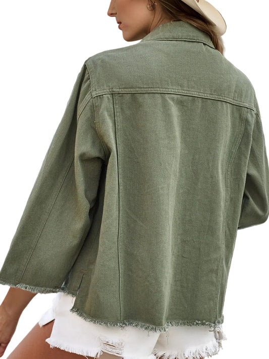 Person wearing a green denim jacket with a horse painting in the background