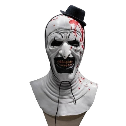 Horror-themed mask with white face, red accents, and black hat on a black background