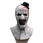 Horror-themed mask with white face, red accents, and black hat on a black background