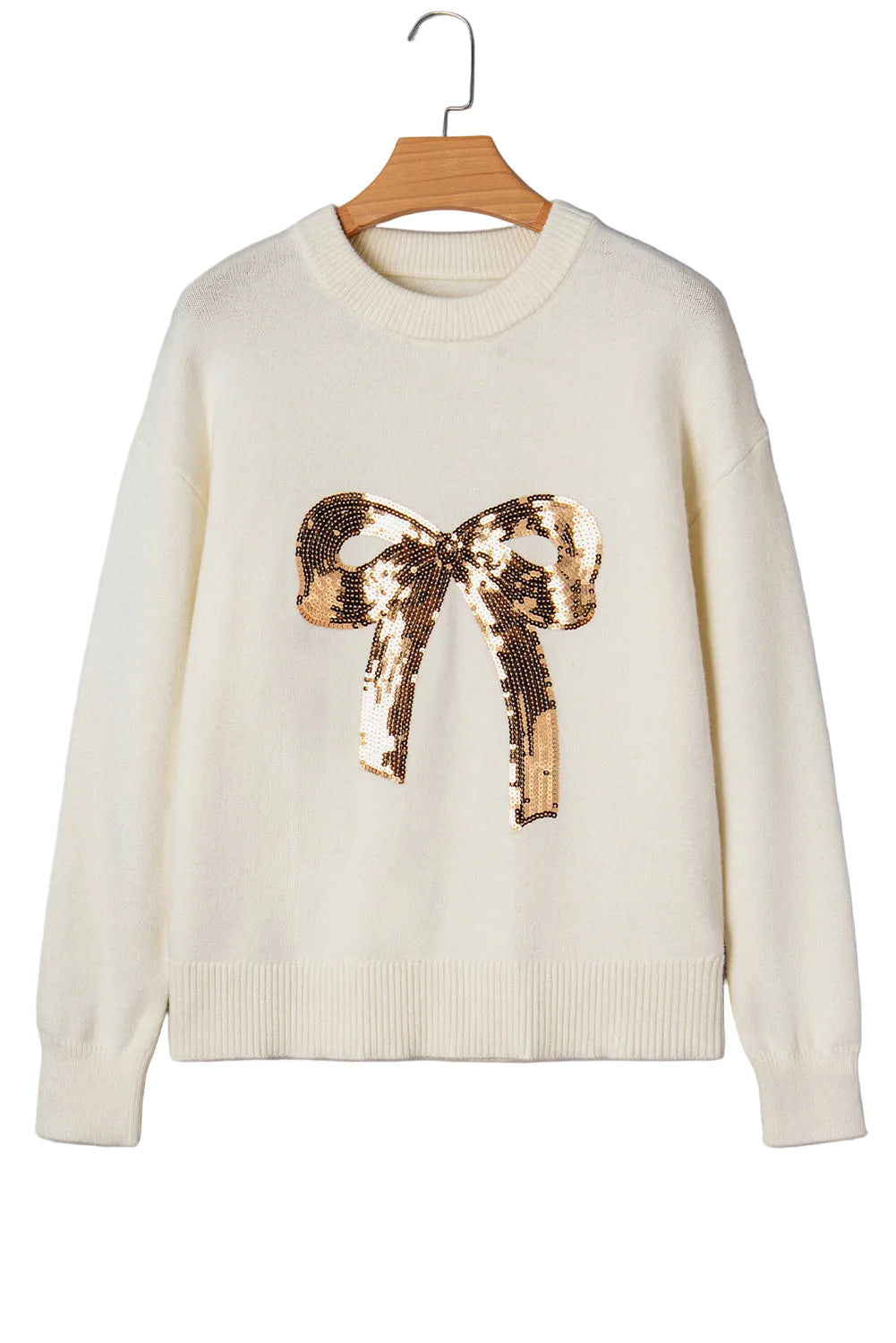 White sweater with a gold sequin bow on a gray background