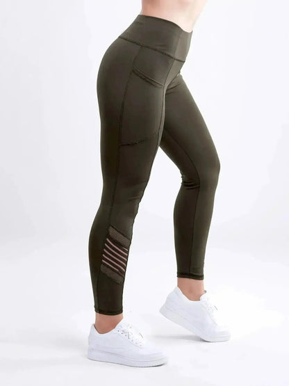 Olive green leggings with white sneakers on a white background