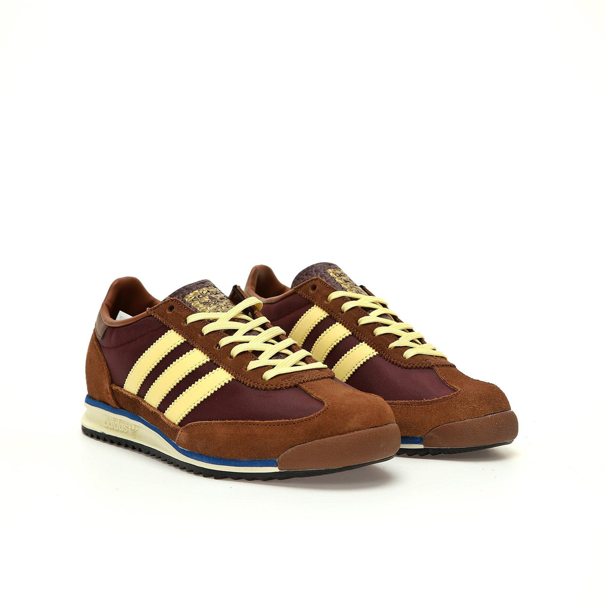 Brown and yellow Adidas sneakers on a white background