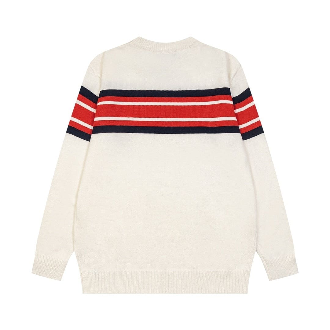 An off-white knit sweater with a horizontal stripe pattern across the chest and upper sleeves in red, white, and navy blue, shown from the back on a plain white background.