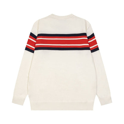 An off-white knit sweater with a horizontal stripe pattern across the chest and upper sleeves in red, white, and navy blue, shown from the back on a plain white background.