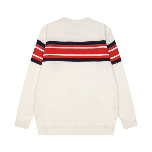 An off-white knit sweater with a horizontal stripe pattern across the chest and upper sleeves in red, white, and navy blue, shown from the back on a plain white background.