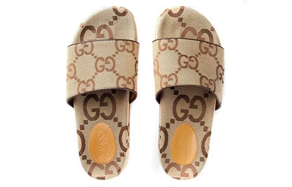 Beige and brown slide sandals with Gucci logo on a white background