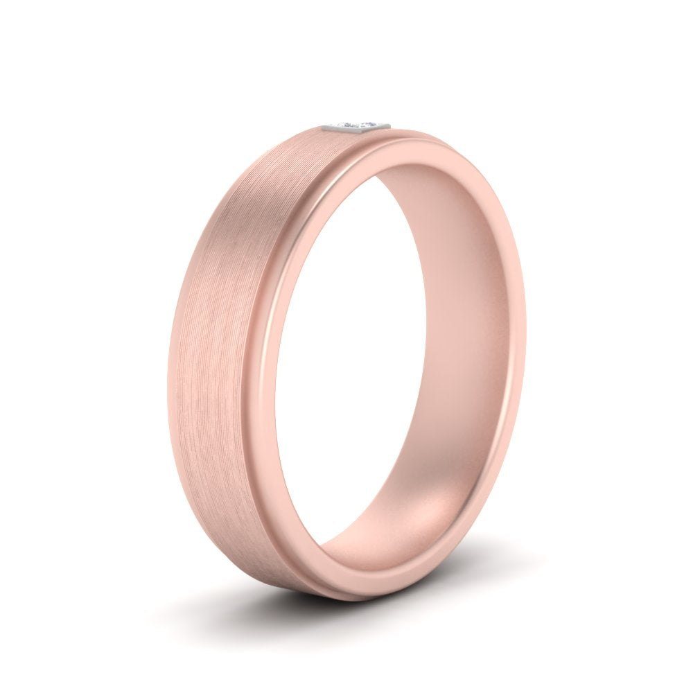 Rose gold ring with a diamond on a white background