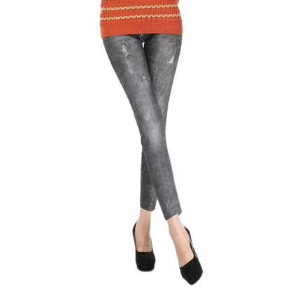 Person wearing gray distressed jeans and an orange sweater on a white background