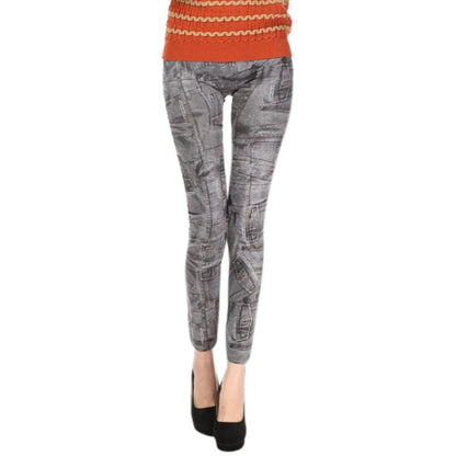 Person wearing gray patterned leggings with an orange sweater on a white background