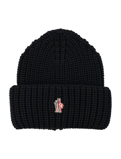 Black knit beanie with a small logo on a white background
