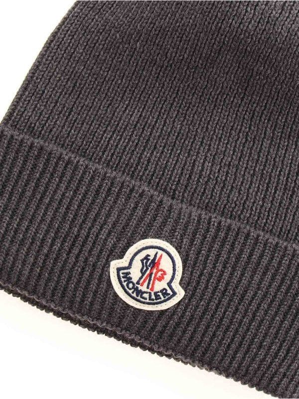 Dark gray knit beanie with a brand logo on a white background