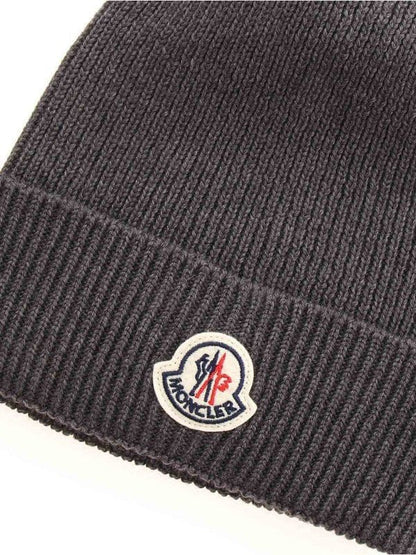 Dark gray knit beanie with a brand logo on a white background