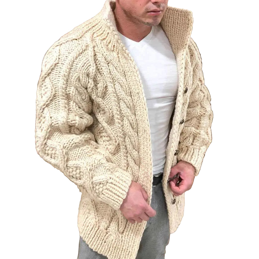 Man wearing a beige cable knit cardigan over a white shirt.