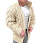 Man wearing a beige cable knit cardigan over a white shirt.