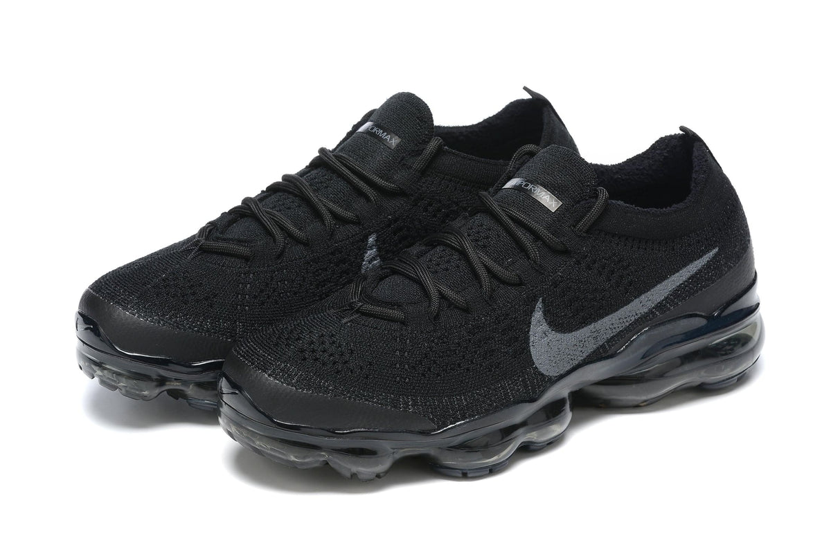 Black athletic shoes with a brand logo on a white background