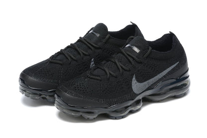 Black athletic shoes with a brand logo on a white background