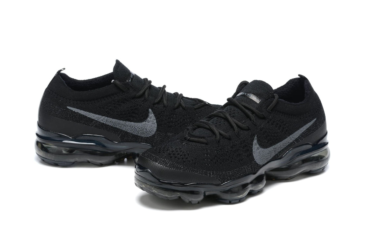 Black Nike sneakers with visible brand logo on a white background