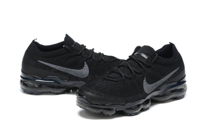 Black Nike sneakers with visible brand logo on a white background